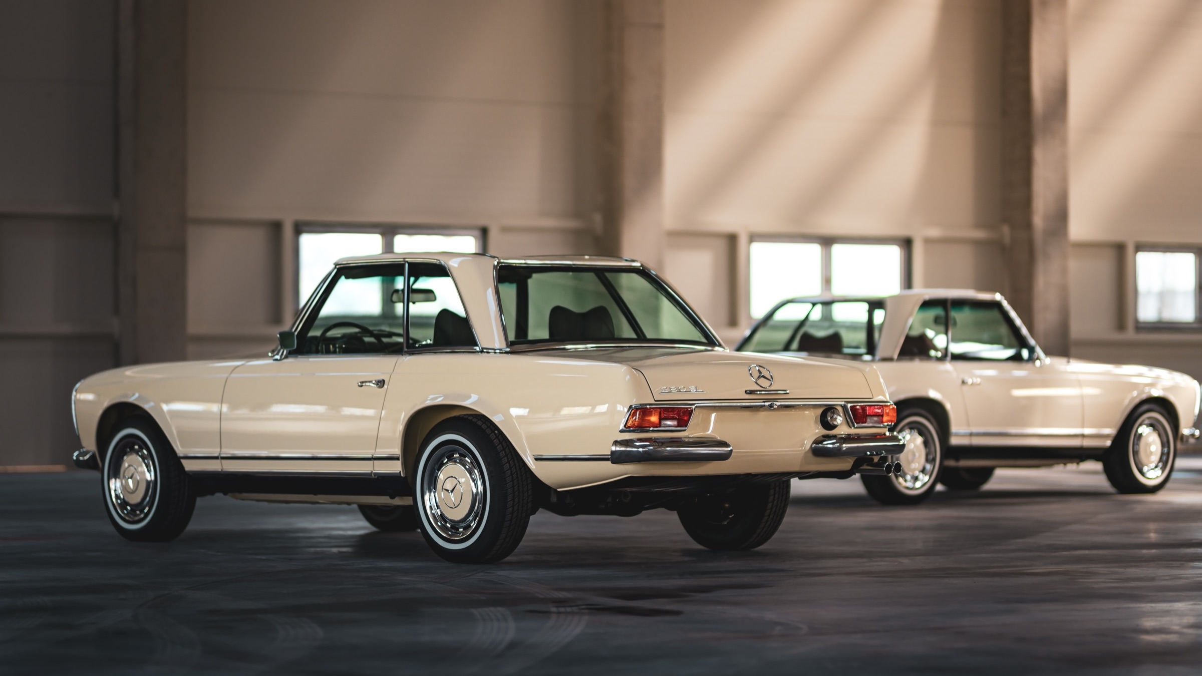 Cream Pagoda with the hardtop, rear three-quarter view, a second Pagoda behind it