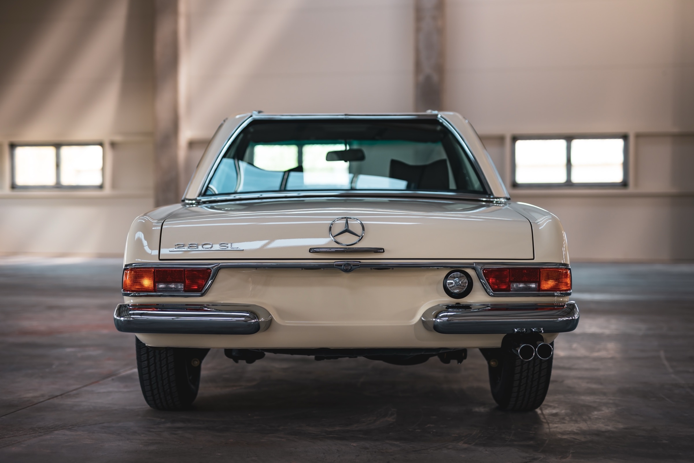 Rear view of a cream 280 SL Pagoda with the hardtop