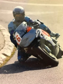 A racer cornering on a racing motorcycle, number 6