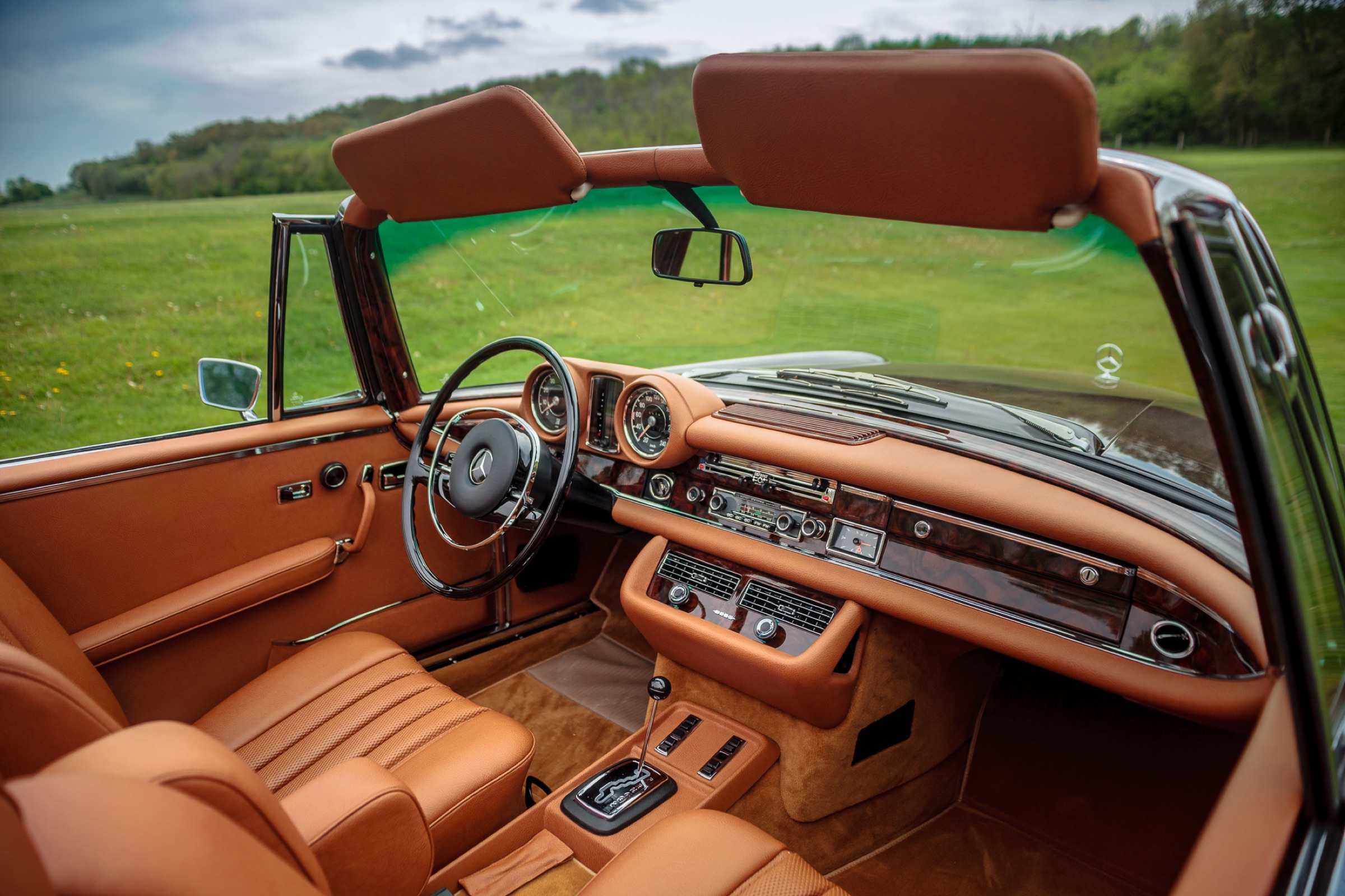 Tan leather interior and wooden dashboard of a W111 convertible